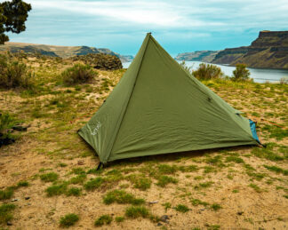 River country products trekker 1 trekking pole tent backpacking tent set up next to river with backpack