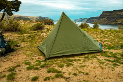 River country products trekker 1 trekking pole tent backpacking tent set up next to river with backpack