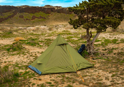 River country products trekker 1 trekking pole tent backpacking tent set up next to river with backpack