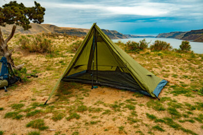 River country products trekker 1 trekking pole tent backpacking tent set up next to river with backpack