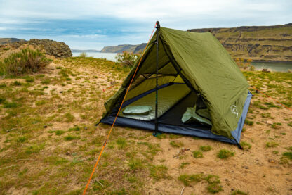 River country products trekker 2.2 trekking pole tent backpacking tent set up next to river with sleeping pads