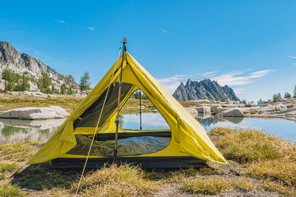 backpacking trekking pole tent set up near water