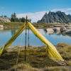 backpacking trekking pole tent outer shell set up near water