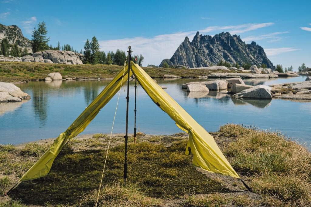 backpacking trekking pole tent outer shell set up near water