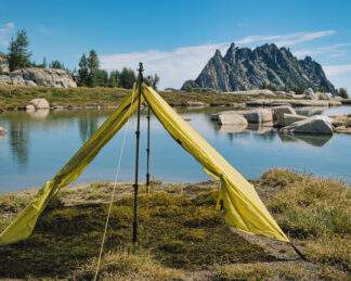 backpacking trekking pole tent outer shell set up near water
